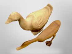 A carved wooden duck ornament and a further papier mache figure,