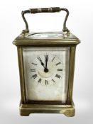An antique brass carriage timepiece, height 14.5cm including handle.