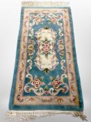 Two Chinese rugs on turquoise ground,