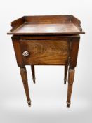 A 19th century mahogany pot cupboard with galleried top,