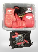 A box containing various boxing gloves, skipping rope.