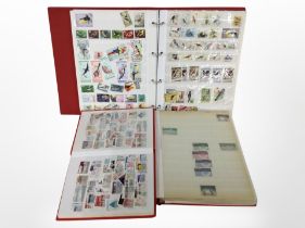 Three albums of assorted world stamps.