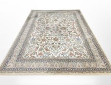 A machine-made carpet of Persian design, 340cm x 240cm.