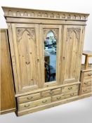 A Gothic style carved pine triple door wardrobe,