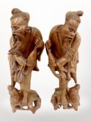 A pair of early 20th-century Chinese carved hardwood figures of fisherman, height 42cm.