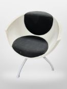 A 20th century moulded plastic swivel armchair on metal support