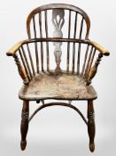 A 19th century stained elm Windsor chair with crinoline understretcher,