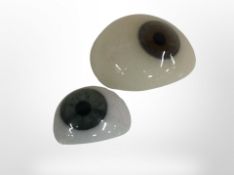 Two antique glass eyes.