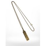 A 9ct gold ingot pendant on chain, pendant 38mm long including loop.