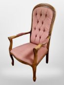 A reproduction armchair in buttoned dralon upholstery