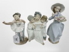 A Lladró figure group of three boys dressed as angels,