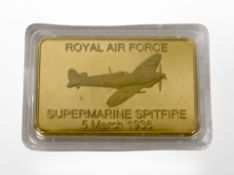 A Royal Air Force commemorative gold-plated Spitfire ingot, width 44mm.