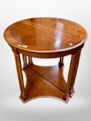 A pair of reproduction yewwood demi lune side tables,