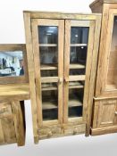 A contemporary mango wood glazed double door cabinet 88 cm wide x 40 cm deep x 178 cm high