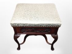 An early 20th century carved mahogany work box stool,