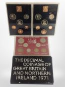 Four cased sets of British coins.