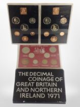 Four cased sets of British coins.