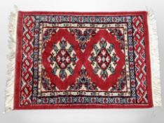 An Iranian rug, on red ground,