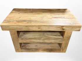 A contemporary mango wood entertainment stand fitted with shelves,