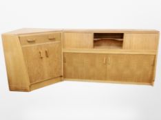 A mid 20th century oak sliding door sideboard and matching corner unit,