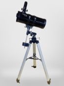A Visionary Telesto 114 telescope on tripod.