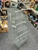 A glass and perspex display rack, height 110cm.
