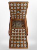 A coin collector's box containing a collection of crowns.