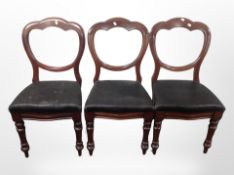 A set of three mahogany balloon backed dining chairs