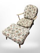 An Ercol stained elm armchair and matching footstool in floral upholstery