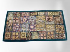 An embroidered throw,