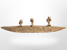 An African carved wooden boat with figures,