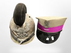 A WWI-style brass Picklehaube helmet, and a further reproduction military cap.