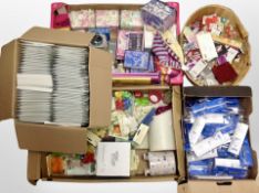 Four boxes containing assorted sundries including candles, pens, mugs, padded envelopes, etc.