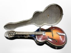 A vintage Hofner President acoustic guitar with Compensator tail-piece, in a hard carry case.