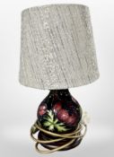 A Moorcroft table lamp with shade, overall height 32cm.