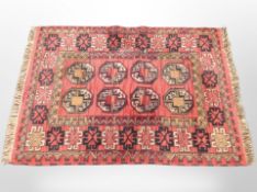 A Bokhara design rug on red ground,