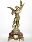 A French rouge marble and gilt metal eight day mantel clock surmounted by a figure of Fortune