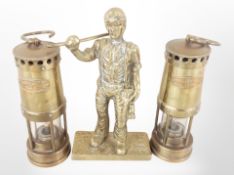 A cast-brass figure of a miner, height 20cm, and two miniature miner's lamps.