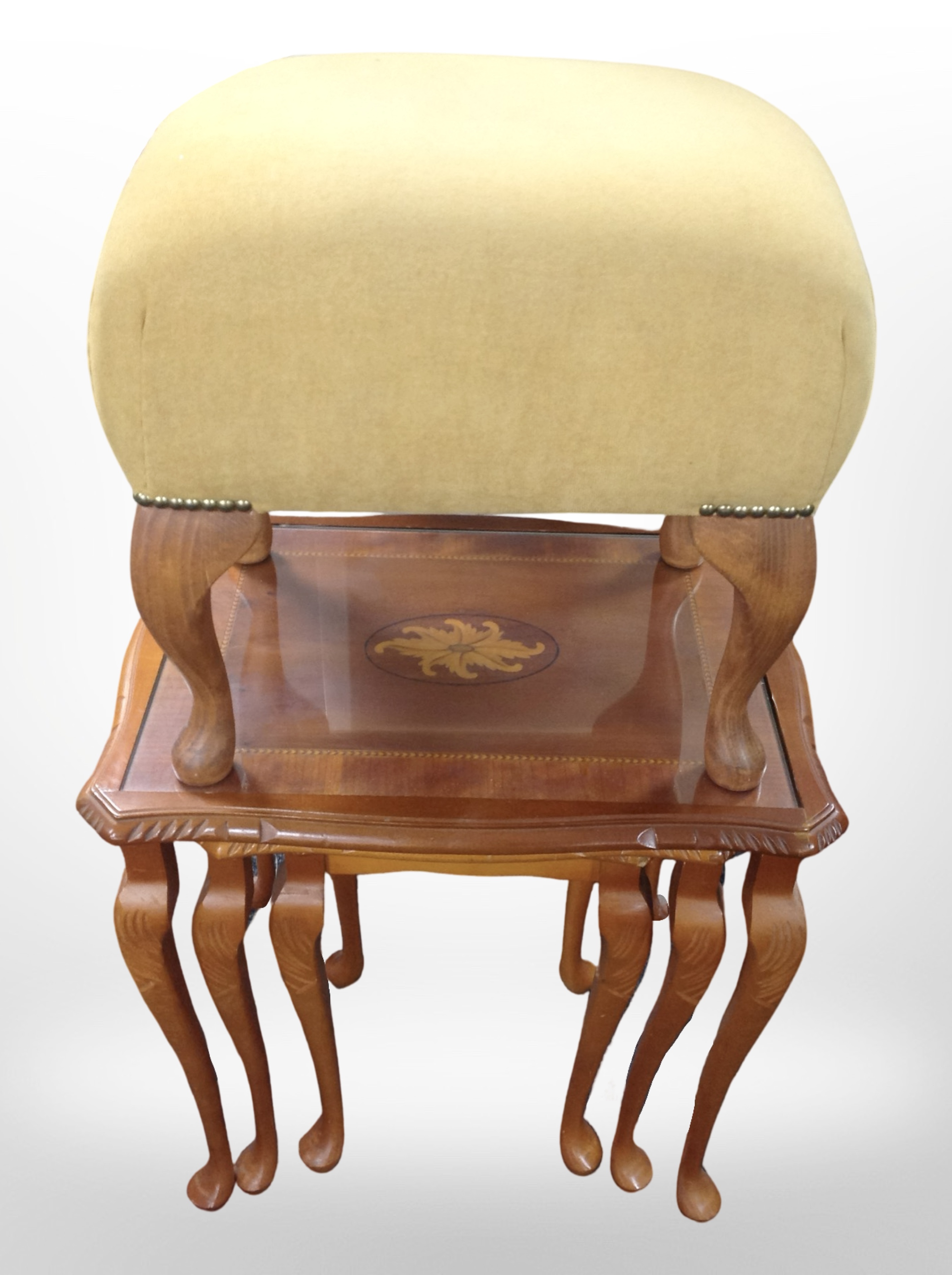 A reproduction nest of three tables and a footstool