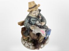 A Capodimonte figure of a tramp on a bench,