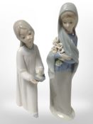 A Lladró figure of a girl in night dress holding a candle,