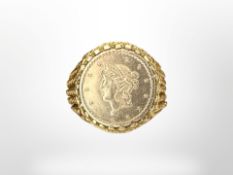 A 9ct gold ring inset with an American 1853 gold tallar coin, size L.