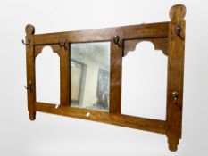 An Arts and Crafts oak mirrored coat rack,