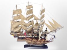 Two models of three masted sailing ships on plinths,