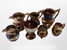 Seven copper lustre jugs.