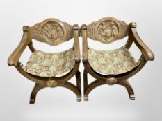 A pair of carved beech savonarola style chairs,