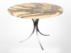 A circular faux marble topped table on chrome support,