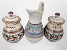 A pair of Spanish ceramic hand painted rice and flower storage jars, and a further jug,