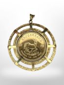 A South African 1oz fine gold Krugerrand 1975 within an 18ct gold textured circular pendant mount,