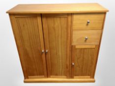 A contemporary bedroom chest fitted with cupboards and drawers,